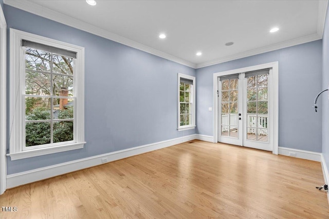 spare room featuring french doors, crown molding, recessed lighting, wood finished floors, and baseboards