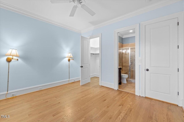 unfurnished bedroom featuring crown molding, light wood-style floors, ceiling fan, ensuite bath, and baseboards