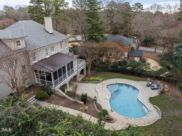 view of pool with a fenced in pool, a sunroom, a patio, and a wooden deck