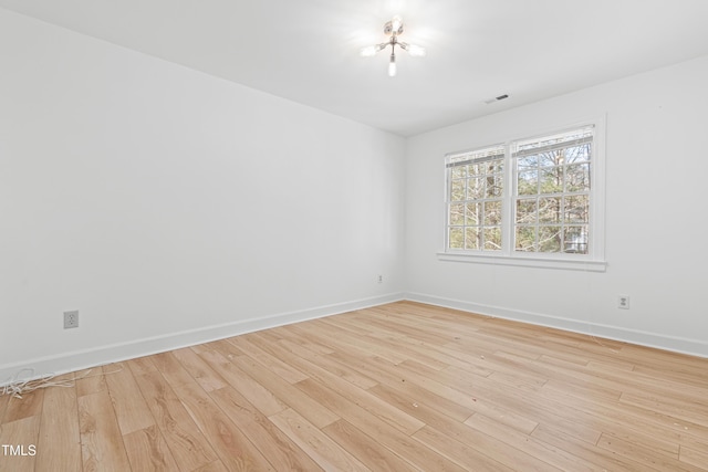 spare room with light wood-type flooring