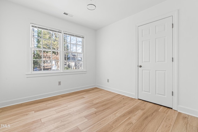 spare room featuring light hardwood / wood-style floors