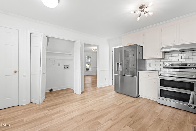 kitchen with white cabinetry, backsplash, light hardwood / wood-style floors, stainless steel appliances, and crown molding