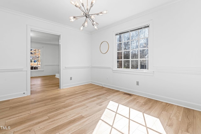 unfurnished dining area with crown molding, a notable chandelier, and light hardwood / wood-style floors