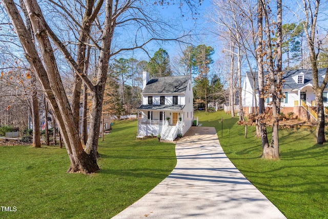 view of front of home featuring covered porch and a front lawn