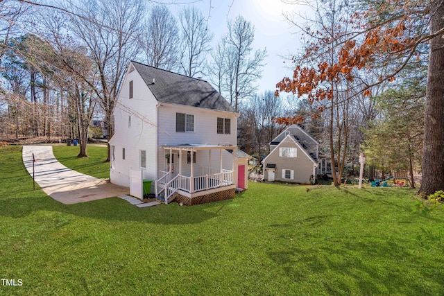 back of house with a porch and a lawn