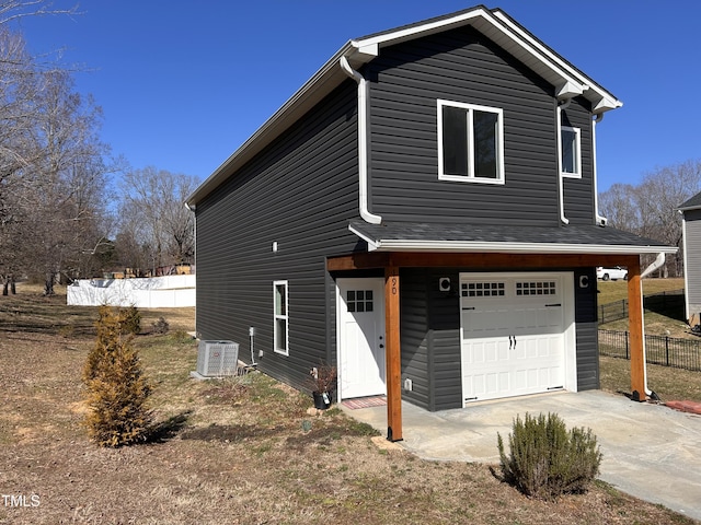 view of front of property with cooling unit and a garage