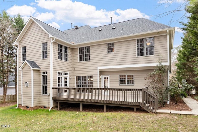 rear view of property featuring a wooden deck and a lawn