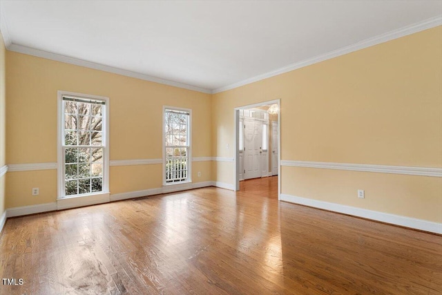 spare room with ornamental molding and light hardwood / wood-style flooring