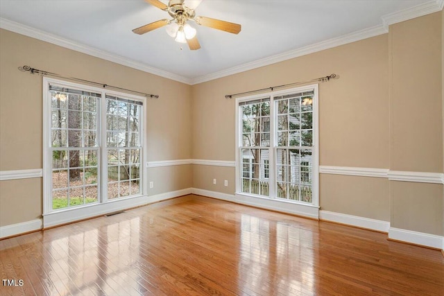 spare room with ceiling fan, plenty of natural light, crown molding, and light hardwood / wood-style floors