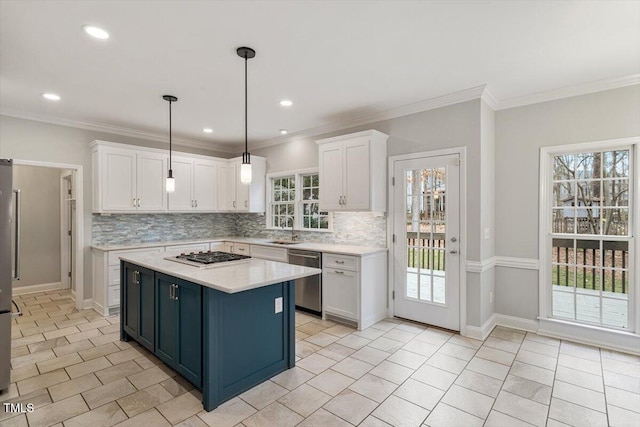 kitchen featuring decorative light fixtures, blue cabinets, white cabinetry, sink, and stainless steel appliances