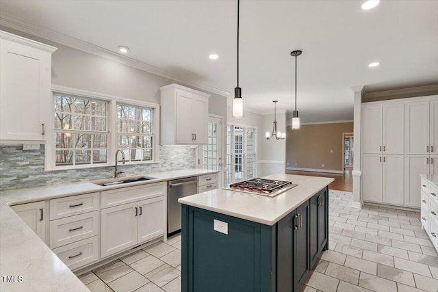 kitchen with sink, white cabinetry, a center island, pendant lighting, and stainless steel appliances