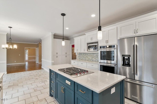 kitchen with blue cabinetry, stainless steel appliances, decorative light fixtures, and white cabinets