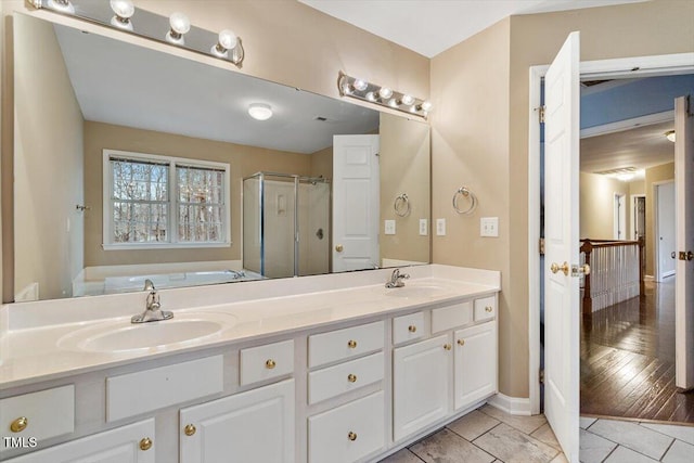 bathroom featuring independent shower and bath, vanity, and tile patterned flooring