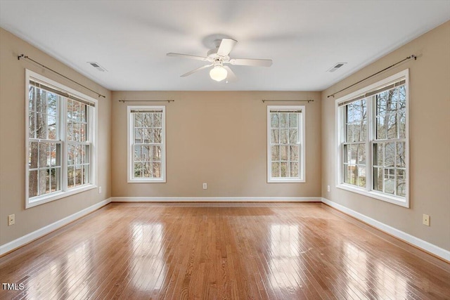 spare room with ceiling fan and light wood-type flooring