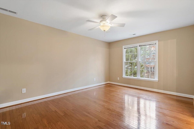 empty room featuring ceiling fan and light hardwood / wood-style floors