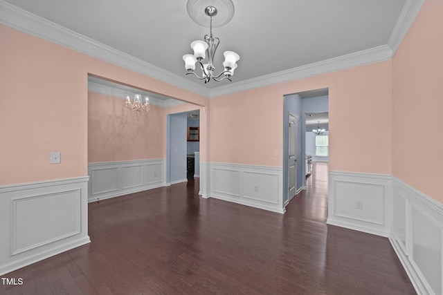 unfurnished dining area featuring a notable chandelier, ornamental molding, and dark hardwood / wood-style floors