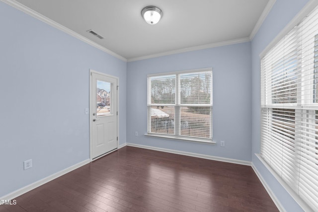 empty room with dark wood-type flooring and ornamental molding