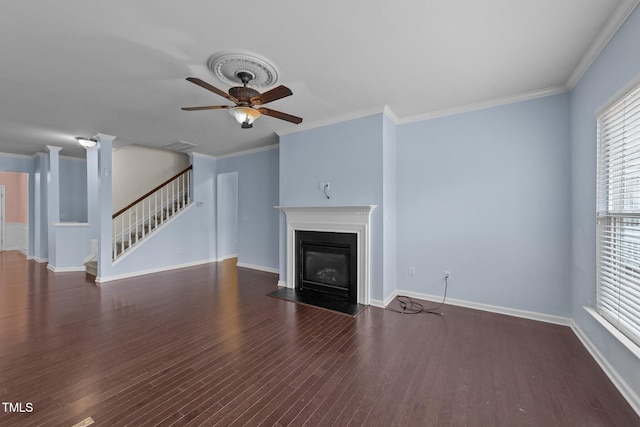 unfurnished living room featuring dark wood-type flooring, ornamental molding, and ceiling fan