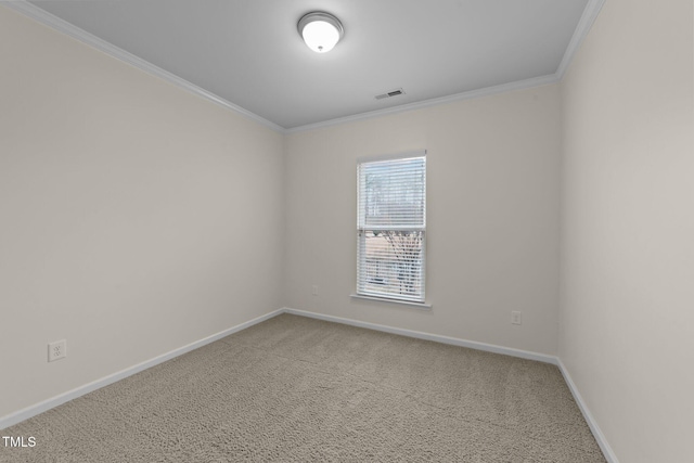 carpeted empty room featuring crown molding