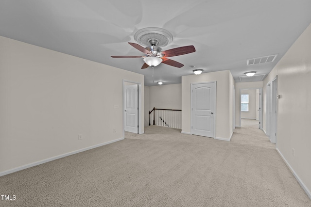 carpeted empty room featuring ceiling fan