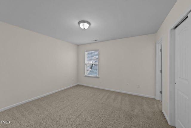 unfurnished bedroom featuring light colored carpet and a closet