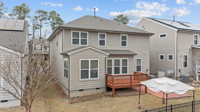 rear view of property featuring a lawn, central air condition unit, and a deck