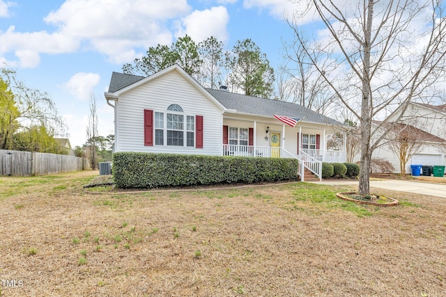 ranch-style home featuring roof with shingles, a porch, a front yard, fence, and driveway