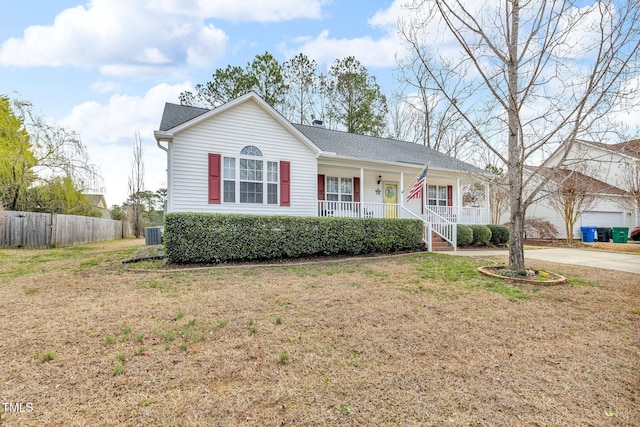 ranch-style home with a porch, a shingled roof, fence, driveway, and a front lawn