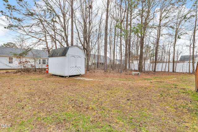 view of yard featuring a shed and an outbuilding