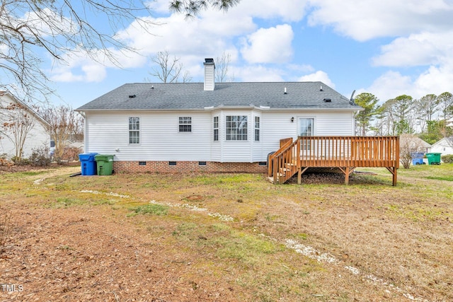 rear view of house featuring crawl space, a chimney, a deck, and roof with shingles