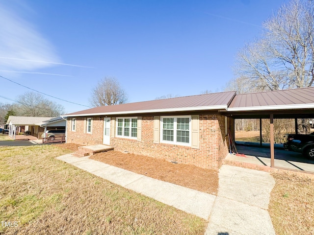 ranch-style home featuring a carport and a front yard