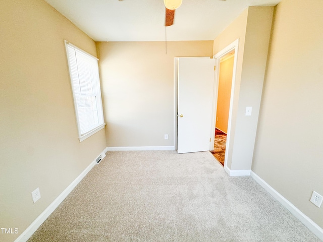 unfurnished room with light colored carpet