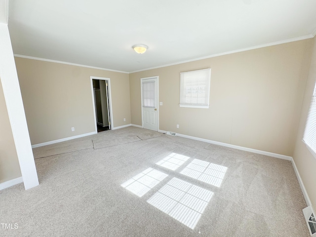 unfurnished room featuring light carpet and crown molding