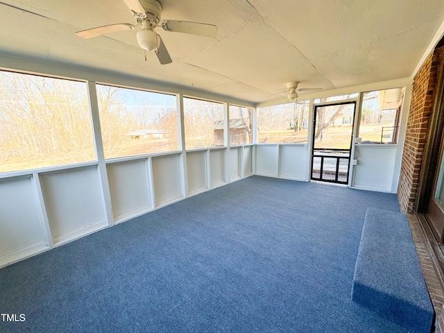 unfurnished sunroom featuring ceiling fan