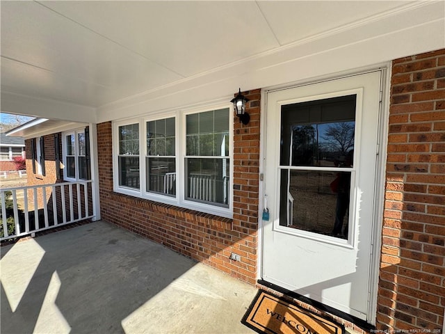 view of exterior entry with a porch