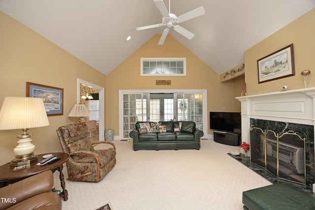 living room with a premium fireplace, high vaulted ceiling, carpet flooring, and ceiling fan