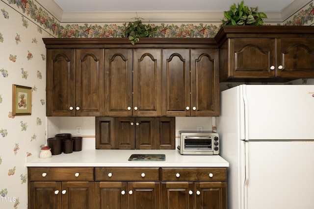 kitchen featuring dark brown cabinets and white refrigerator