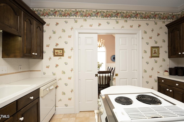 kitchen with light tile patterned flooring, white appliances, sink, and dark brown cabinets