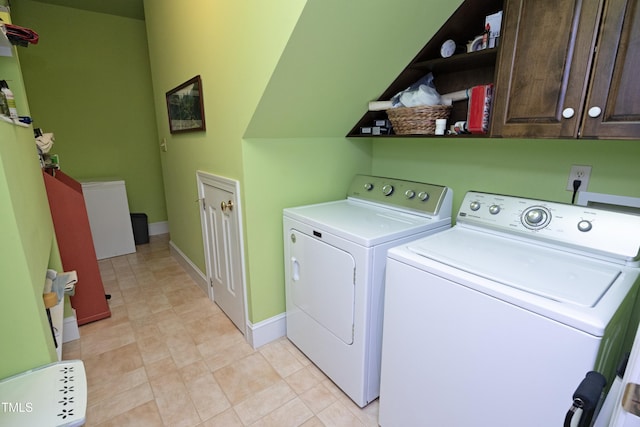 washroom featuring cabinets and washer and dryer