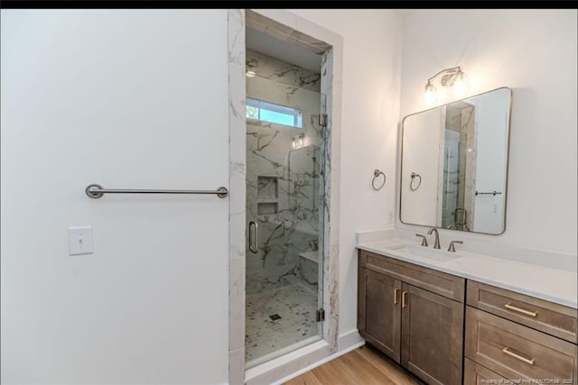 bathroom featuring vanity, an enclosed shower, and hardwood / wood-style floors