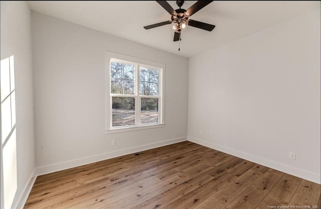 spare room with ceiling fan and hardwood / wood-style floors