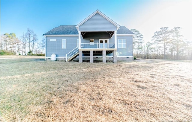 rear view of property with a lawn and a deck