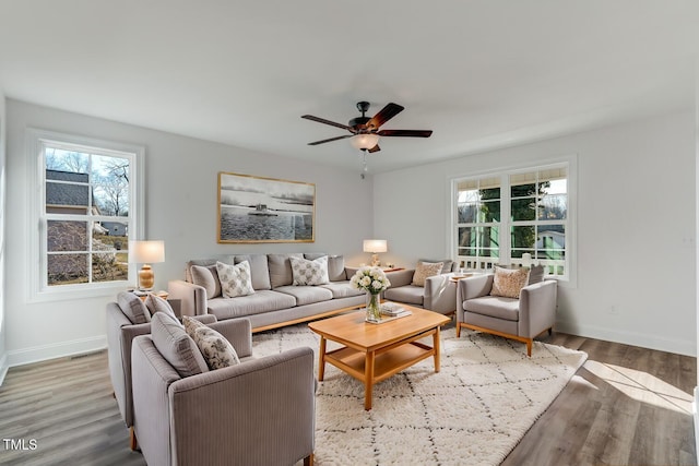 living room featuring ceiling fan and light wood-type flooring