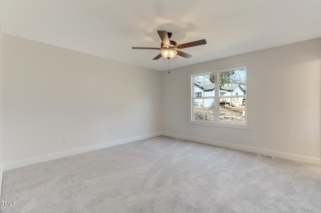 unfurnished room featuring ceiling fan and light carpet