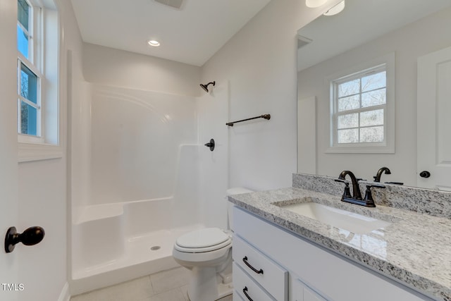 bathroom featuring vanity, tile patterned floors, toilet, and walk in shower