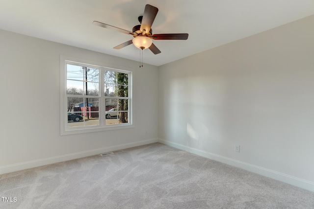 carpeted spare room with ceiling fan