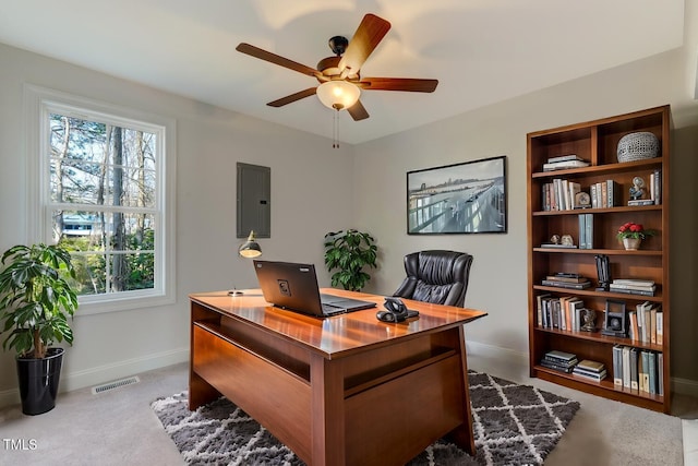 carpeted office featuring electric panel and ceiling fan