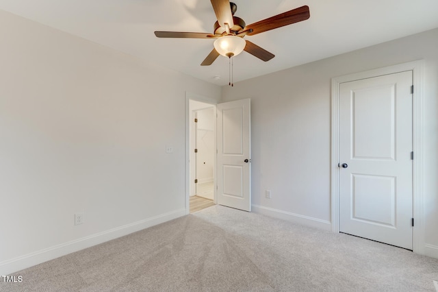 unfurnished bedroom with light colored carpet and ceiling fan