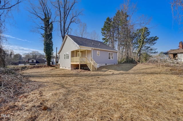 back of property featuring a yard