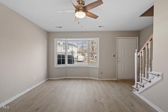 foyer with ceiling fan and light hardwood / wood-style flooring